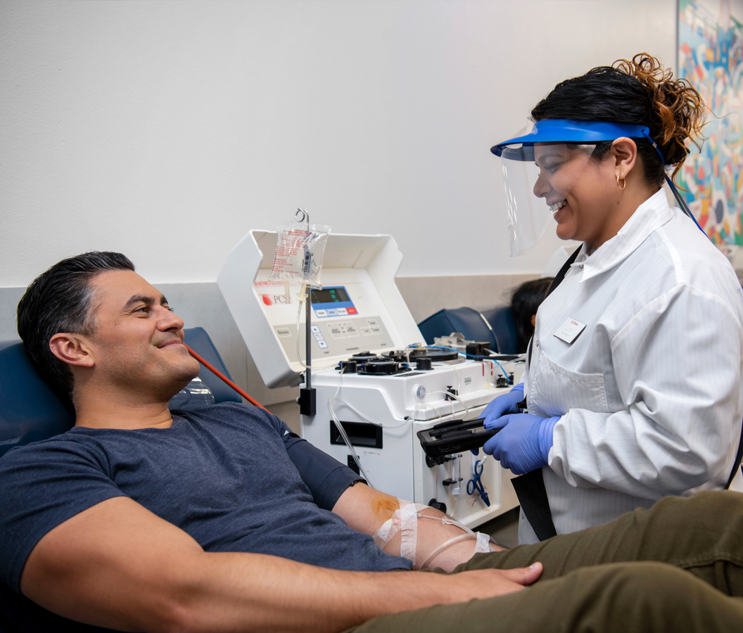 Young man smiling while donating plasma